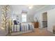 Bright bedroom featuring light blue walls, a twin bed with blue bedding, and a wooden dresser at 308 Wescott Ridge Dr, Holly Springs, NC 27540