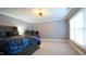 Dark bedroom featuring a bed with decorative bedding, a window, and a ceiling fan at 308 Wescott Ridge Dr, Holly Springs, NC 27540