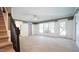 Spacious bonus room features carpet, white wainscoting, several windows, and an exterior door at 308 Wescott Ridge Dr, Holly Springs, NC 27540