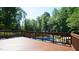 Spacious wooden deck overlooking a sparkling pool surrounded by lush greenery and mature trees at 308 Wescott Ridge Dr, Holly Springs, NC 27540