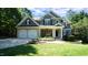 Charming two-story home with stone accents, a two-car garage and a well-manicured front lawn at 308 Wescott Ridge Dr, Holly Springs, NC 27540