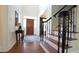 Grand foyer with hardwood floors, staircase with wrought iron railing, and elegant decor sets a welcoming tone at 308 Wescott Ridge Dr, Holly Springs, NC 27540