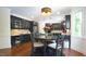 Bright and stylish kitchen with dark cabinetry, granite countertops, modern lighting, and a charming breakfast area at 308 Wescott Ridge Dr, Holly Springs, NC 27540