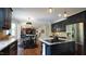 Open-concept kitchen with an island, seating, adjacent dining, and living space creates seamless entertaining flow at 308 Wescott Ridge Dr, Holly Springs, NC 27540