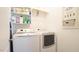 Functional laundry room equipped with modern washer and dryer units and ample shelving at 308 Wescott Ridge Dr, Holly Springs, NC 27540