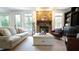 Inviting living room with a stone fireplace, natural light, and stylish furnishings creates a comfortable retreat at 308 Wescott Ridge Dr, Holly Springs, NC 27540