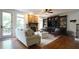 Inviting living room with stone fireplace, built-in shelves, and hardwood floors at 308 Wescott Ridge Dr, Holly Springs, NC 27540