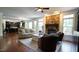 Cozy living room with stone fireplace, comfortable seating, and views to the open-concept kitchen enhance gatherings at 308 Wescott Ridge Dr, Holly Springs, NC 27540