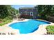Backyard with an in-ground pool, lounge chairs, and a wooden deck, creating an inviting outdoor oasis at 308 Wescott Ridge Dr, Holly Springs, NC 27540