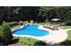 Beautiful pool with waterfall, lounge chairs, and covered bar amidst landscaped greenery, ideal for outdoor enjoyment at 308 Wescott Ridge Dr, Holly Springs, NC 27540