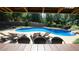 Relaxing poolside view featuring lounge chairs and waterfall, creating an inviting outdoor leisure space at 308 Wescott Ridge Dr, Holly Springs, NC 27540