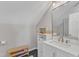 Well-lit bathroom featuring a single sink vanity, wooden bench, and large mirror at 3119 Guiding Light Rd, Raleigh, NC 27610