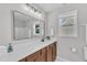 Bright bathroom featuring a modern vanity with a large mirror and plenty of natural light at 3119 Guiding Light Rd, Raleigh, NC 27610
