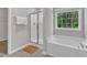 Bright bathroom features a tub, separate glass shower and large window letting in natural light at 3119 Guiding Light Rd, Raleigh, NC 27610