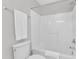Clean bathroom with white tub and shower combo, matching toilet and towel at 3119 Guiding Light Rd, Raleigh, NC 27610