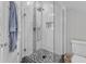 This bathroom features a glass shower with tile accents and a pebble floor at 3119 Guiding Light Rd, Raleigh, NC 27610