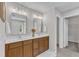 Bathroom features double sink vanity with new fixtures and vanity lighting and access to a private room at 3119 Guiding Light Rd, Raleigh, NC 27610