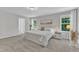 Bedroom with ensuite access features neutral walls and plush carpet, two large windows with a view at 3119 Guiding Light Rd, Raleigh, NC 27610