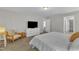 Bedroom with neutral walls and plush carpet with television and ensuite access to closet and bath at 3119 Guiding Light Rd, Raleigh, NC 27610