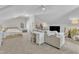 Large bonus room featuring a TV, work area, and bedroom space with carpeted floors at 3119 Guiding Light Rd, Raleigh, NC 27610