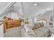 Spacious bonus room with a couch, shelving, and carpeted floors at 3119 Guiding Light Rd, Raleigh, NC 27610