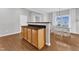 Bright dining area features wood floors, white table set, and a window that provides lots of natural light at 3119 Guiding Light Rd, Raleigh, NC 27610