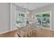 This dining room has hardwood floors, a white table with six chairs, and a sliding glass door at 3119 Guiding Light Rd, Raleigh, NC 27610