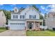 Charming two-story home with white siding, brick accents, and a well-manicured lawn at 3119 Guiding Light Rd, Raleigh, NC 27610