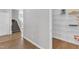 Hallway featuring wood and carpet floors leading to stairs and an adjacent pantry area at 3119 Guiding Light Rd, Raleigh, NC 27610