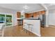 Modern kitchen with wood cabinets, stainless steel appliances, and a view to the backyard at 3119 Guiding Light Rd, Raleigh, NC 27610