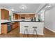 Well-lit kitchen with wood cabinets, stainless steel appliances, and bar stool seating at 3119 Guiding Light Rd, Raleigh, NC 27610