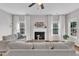 Spacious living room featuring comfortable seating, a fireplace, and hardwood floors at 3119 Guiding Light Rd, Raleigh, NC 27610
