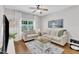Cozy living room with hardwood floors, comfortable seating, and bright natural light at 3119 Guiding Light Rd, Raleigh, NC 27610