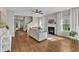 Bright living room featuring hardwood floors, a fireplace, and large windows at 3119 Guiding Light Rd, Raleigh, NC 27610
