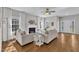 Elegant living room with hardwood floors, a cozy fireplace, and ample natural light at 3119 Guiding Light Rd, Raleigh, NC 27610