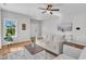 Inviting living room featuring a plush sofa, hardwood floors, and an open layout at 3119 Guiding Light Rd, Raleigh, NC 27610