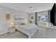 Carpeted main bedroom features a queen bed, side tables with lamps, a window and a TV stand at 3119 Guiding Light Rd, Raleigh, NC 27610