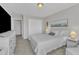 Main bedroom has a queen bed with side tables, white walls, and a large closet at 3119 Guiding Light Rd, Raleigh, NC 27610