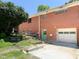 Brick house with a green door leading to the backyard and an attached garage, providing convenience and charm at 3323 Baugh St, Raleigh, NC 27604