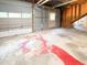 Spacious unfinished basement with garage door entrance, concrete floor, and exposed beam ceiling at 3323 Baugh St, Raleigh, NC 27604