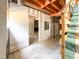 Unfinished basement space with exposed wood ceiling and staircase leading to upper level at 3323 Baugh St, Raleigh, NC 27604
