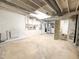 Spacious unfinished basement with white brick fireplace and door to unfinished bathroom at 3323 Baugh St, Raleigh, NC 27604