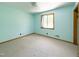 Bright bedroom featuring neutral carpet, light blue walls, and a window with natural light at 3323 Baugh St, Raleigh, NC 27604