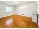 Bright bedroom with hardwood floors, white walls, plantation shutters, and adjacent sink and vanity at 3323 Baugh St, Raleigh, NC 27604