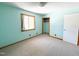 Bedroom featuring neutral carpet, light blue walls, closet with rack, and a window with natural light at 3323 Baugh St, Raleigh, NC 27604