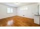 Bright bedroom with hardwood floors, white walls, plantation shutters, and adjacent sink and vanity at 3323 Baugh St, Raleigh, NC 27604