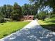 Lovely brick home with a large tree in the front yard and a long driveway for convenient parking at 3323 Baugh St, Raleigh, NC 27604