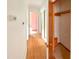 Hallway featuring hardwood floors and access to multiple rooms at 3323 Baugh St, Raleigh, NC 27604