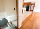 View from staircase to kitchen with black refrigerator and wooden cabinets and island at 3323 Baugh St, Raleigh, NC 27604