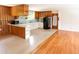 The kitchen boasts wood paneling, white cabinets and adjacent living space at 3323 Baugh St, Raleigh, NC 27604